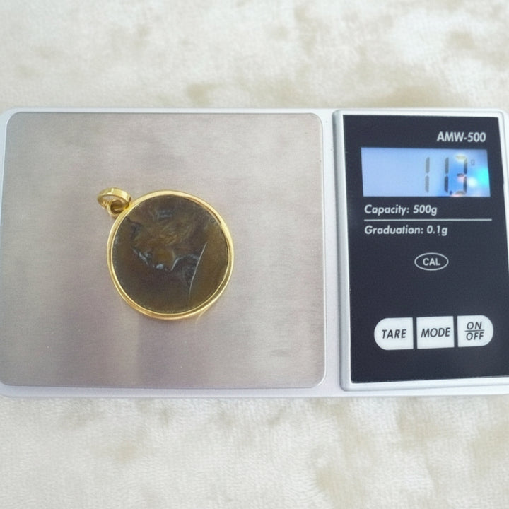 Perseus Pendant in Bronze & 24k Gold on jewelry scale.