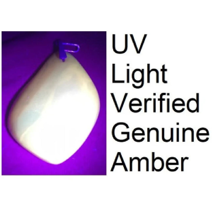 1950s Soviet Era Butterscotch Amber Pendant under UV light.