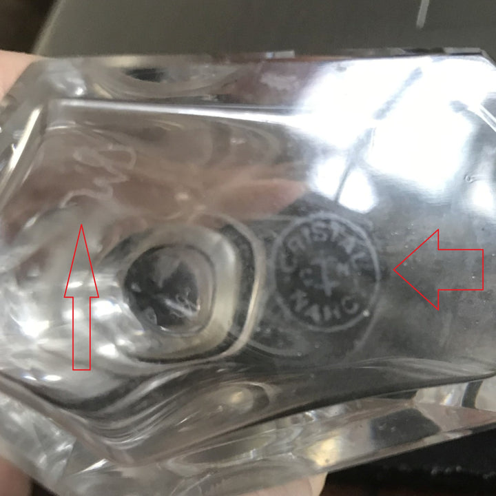 Cristalleries de Nancy Art Deco Crystal Perfume Bottle, laying on side at three quarter angle, base, Close=up showing insignia and makers mark.