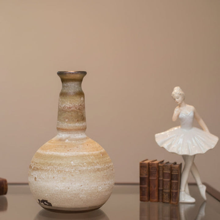 1960s Argentinian Mingus Glass Miniature Perfume Bottle and ballerina figurine on a reflective surface with a neutral background