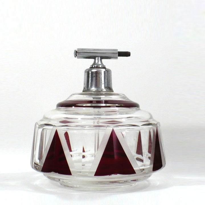 Karl Palda Art Deco perfume bottle atomizer with a metal top and red and clear geometric crystal body.