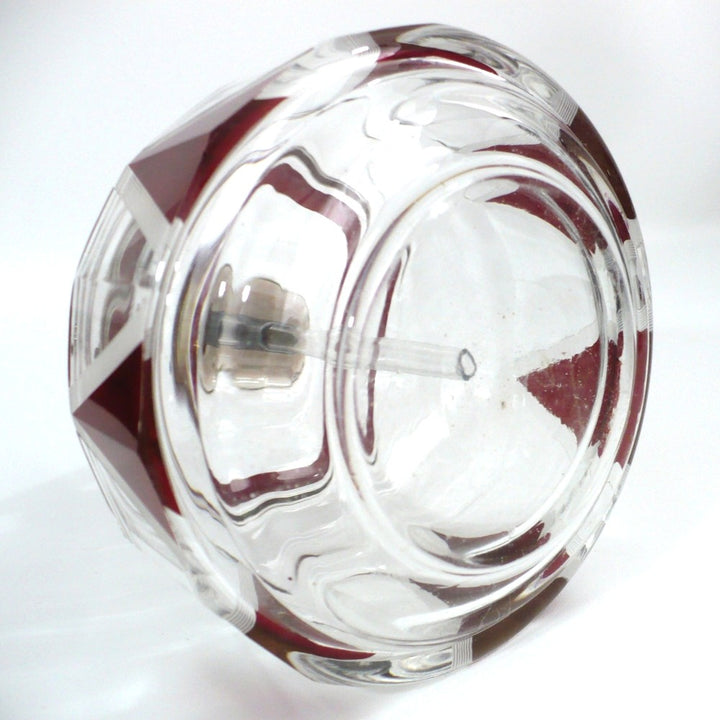 Close-up viewo f atomizer with assembled parts seen in the interior through the clear crystal body.