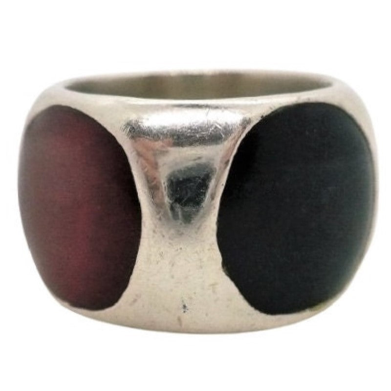 A vintage 1960s silver band ring with multiple inlaid gemstones including red carnelian, black onyx, and bloodstone.