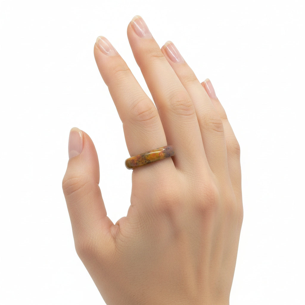 Hand wearing Rainbow jasper hololith ring with white ackground.