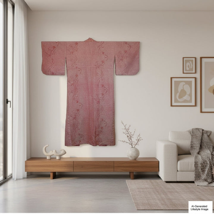 Living room with a kimono hanging on the wall, a sofa, and decorative items.