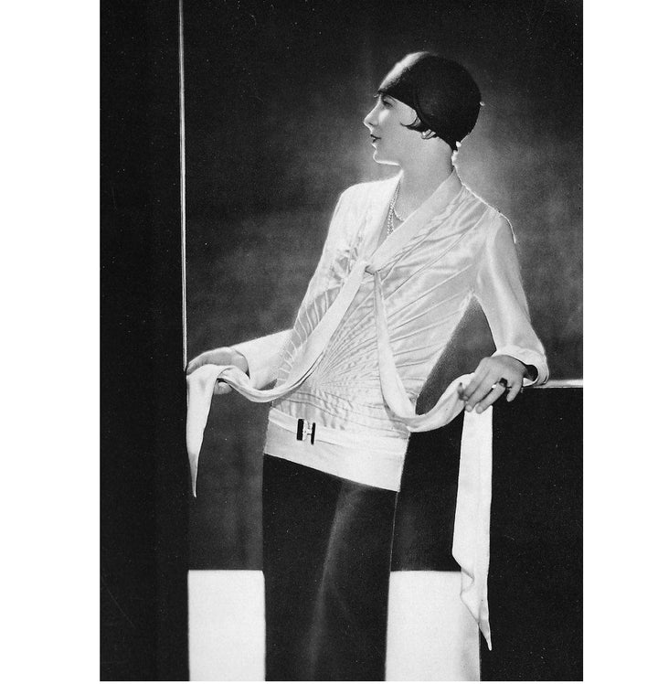 Black and white photograph of a woman in a stylish outfit from the 1920s showing very long scarf.