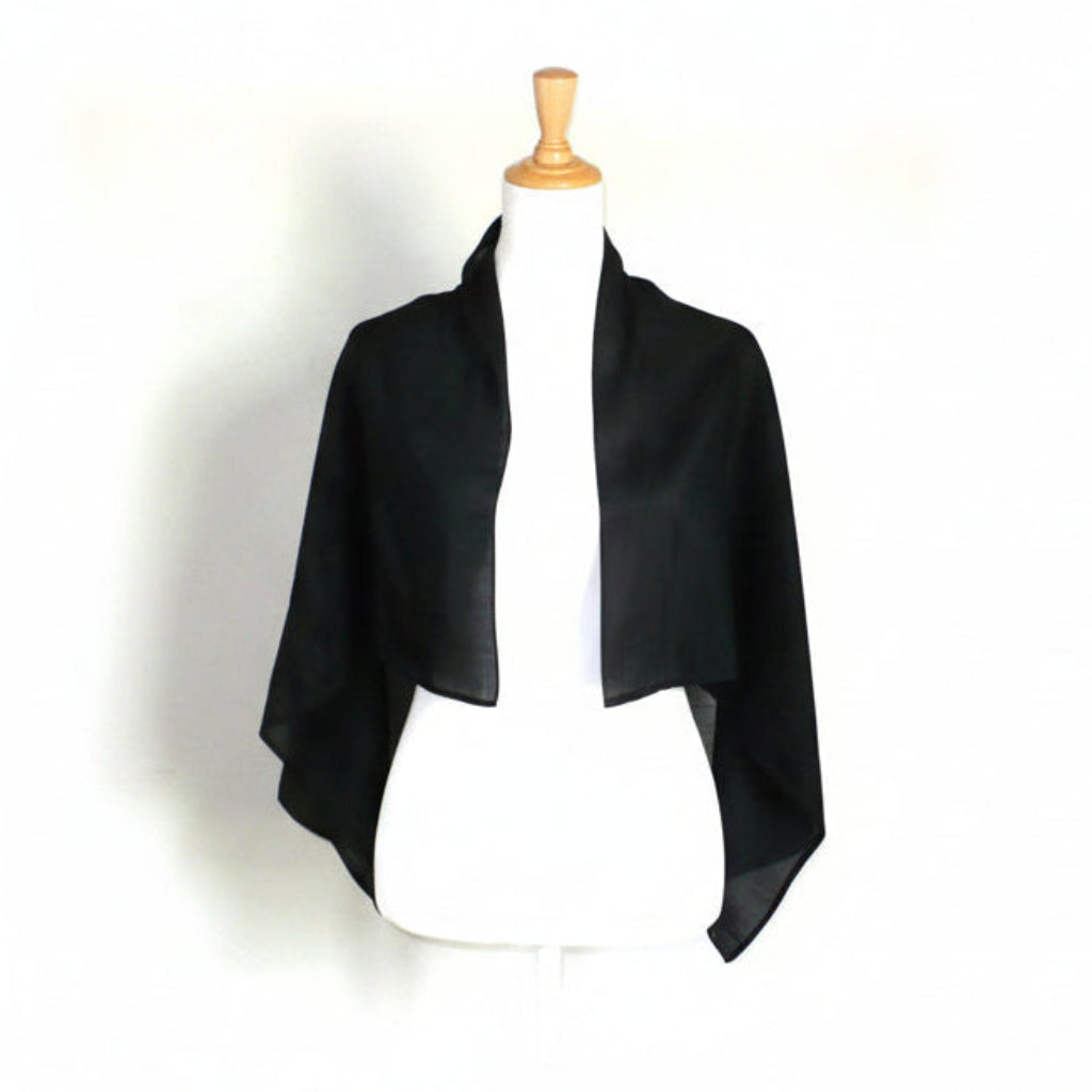 1800s Victorian black glazed cotton mourning scarf draped on a white dress form torso.