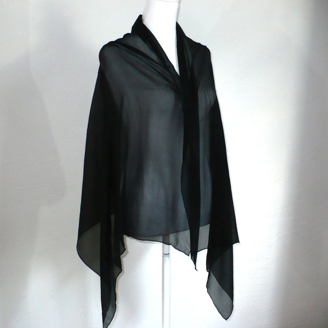 Black scarf on a mannequin against a white background.