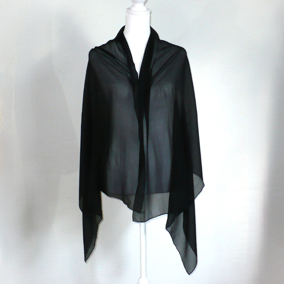 Black scarf on a mannequin against a white background.