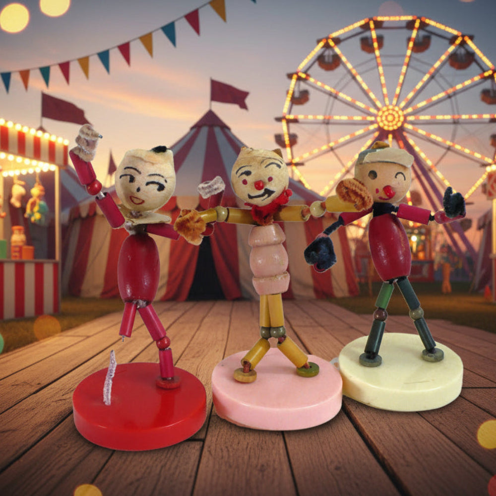 Set of 3 Walco Pixie Puppets Dolls – 1960s Vintage Pipe Cleaner Toys. carnival-themed figurines on a wooden platform with a Ferris wheel and circus tent in the background.