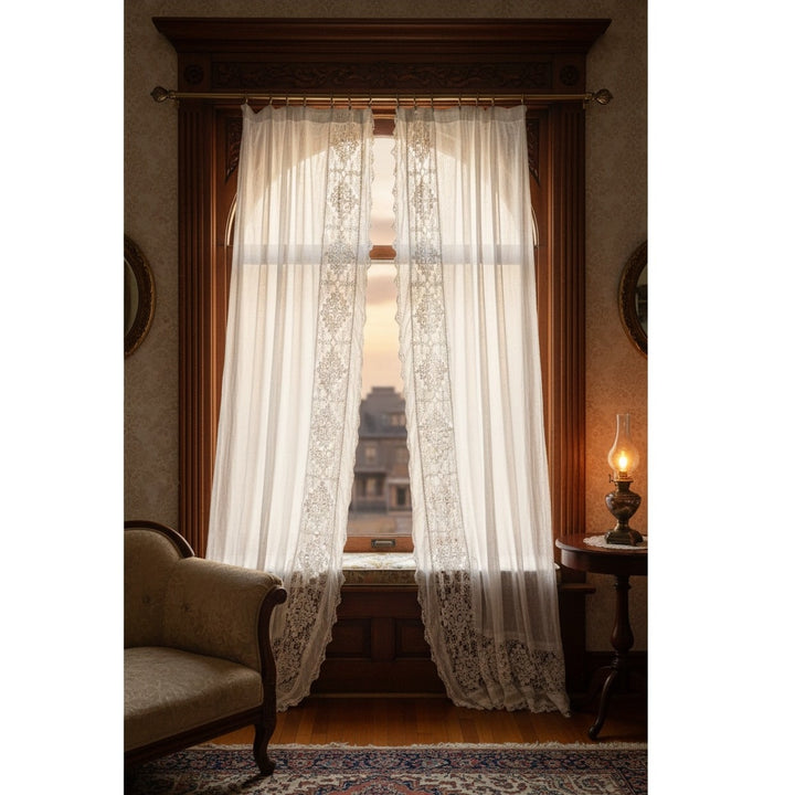 Sheer lace curtains in a room with a lamp and sofa.