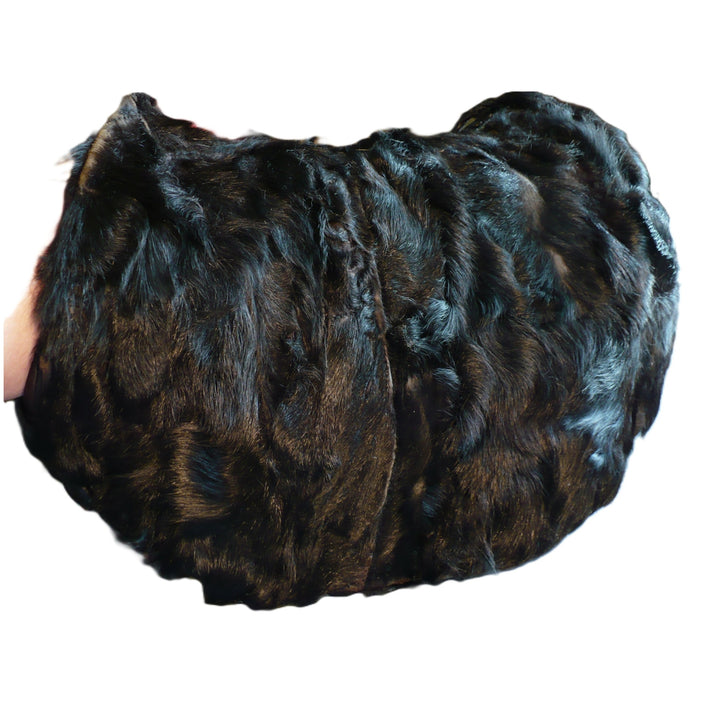 Vintage 1960s black broadtail lamb fur muff handbag showing the rich, watered-silk moiré texture against a white background.