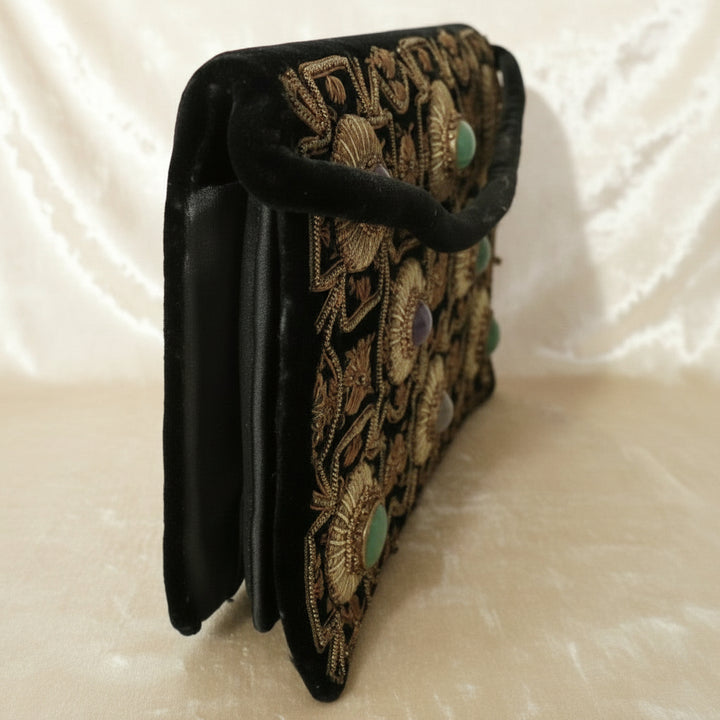 1940s Vintage Black Velvet Anglo-Indian Genuine Gemstone Handbag, side view, creamy velvet background.