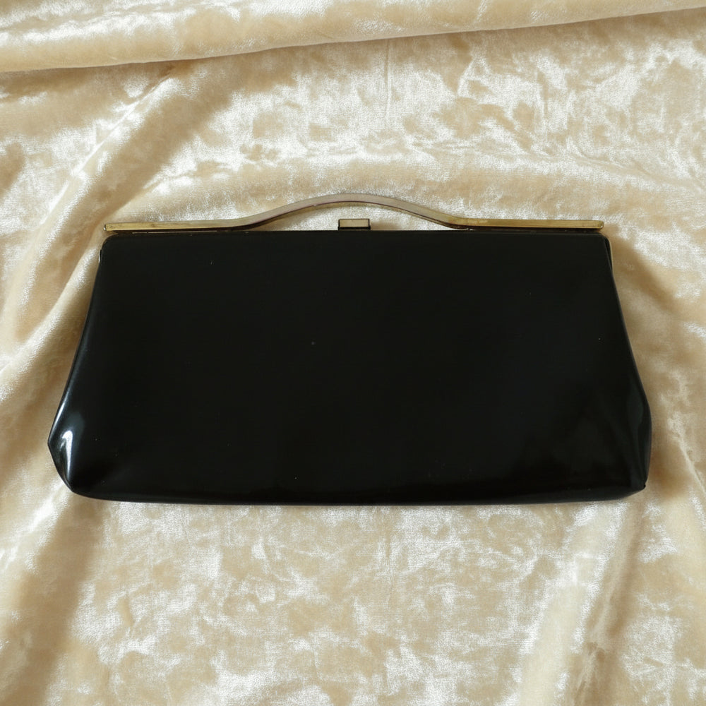 1964 Vintage Black Patent-look Cutout Handle Long Slender Handbag.