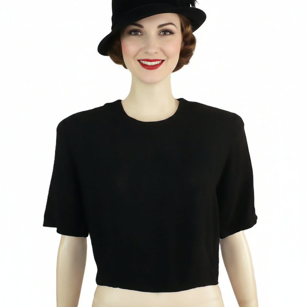 1940s Vintage Black Pebble Crepe Top Blouse With Shoulder Pads on woman with plain background