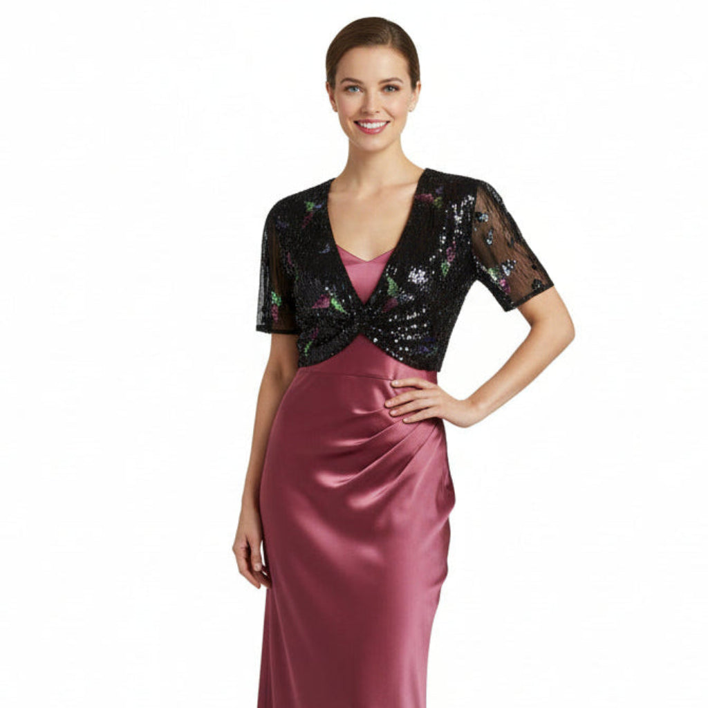 Woman wearing a black sequin top and pink satin skirt on a white background