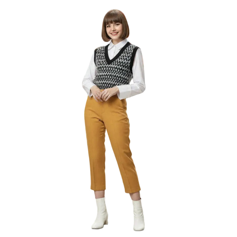 Person wearing a patterned vest, white shirt, 1960s Vintage Scooter Girl Mod Italian Isle Capris Pants, and white shoes on a white background