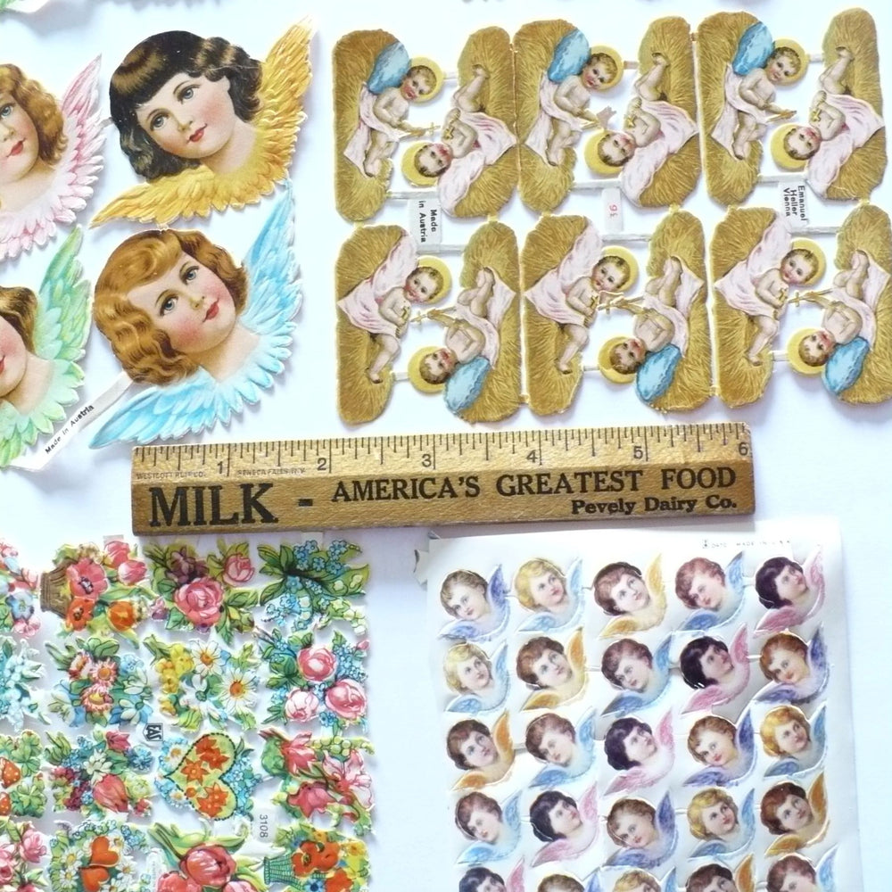 This image shows  a 6-inch ruler next to vintage embossed paper die-cuts.