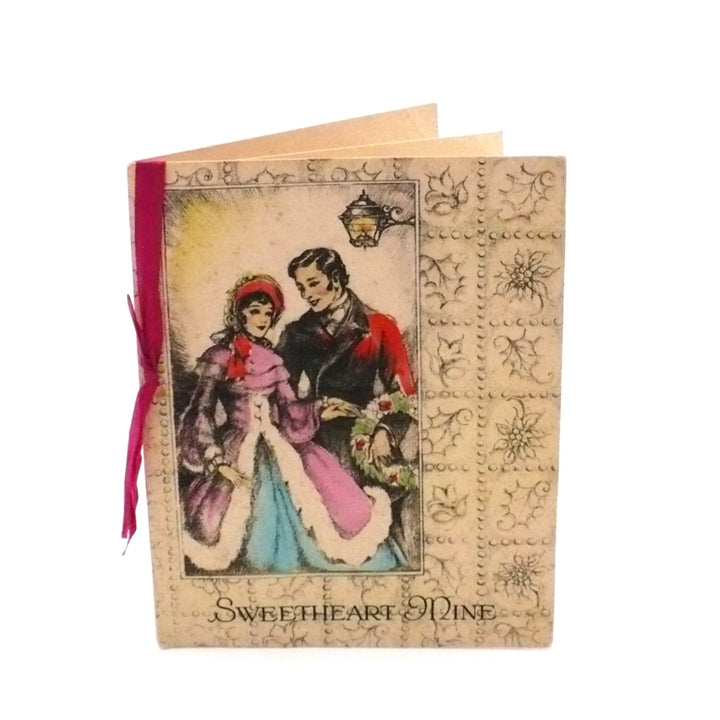 This elegant vintage Christmas card, titled Sweetheart Mine, features a sentimental holiday message for a romantic partner. The interior is decorated with a vibrant red poinsettia and holly sprig at the top, accompanied by delicate floral accents around the verse. The red satin ribbon from the cover is visible, serving as a decorative tie for the panels.