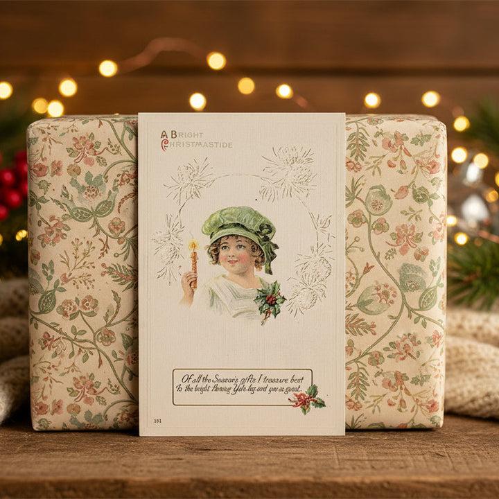 Decorative Christmas packaging with floral patterns and a 1913 Christmastide Vintage Regency Girl with Candle Christmas Postcard.