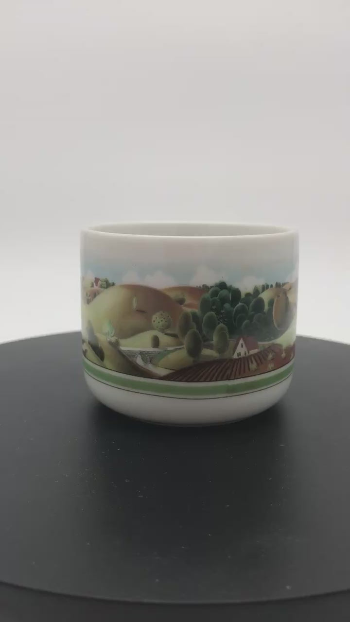 1980 Estée Lauder Porcelain Folk Art Tea Light Candle Holder on a rotating platform to show all sides.