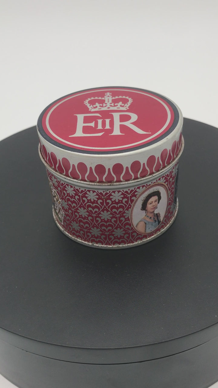 1977 Queen Elizabeth II Silver Jubilee Matchbox Tin on a rotating base.